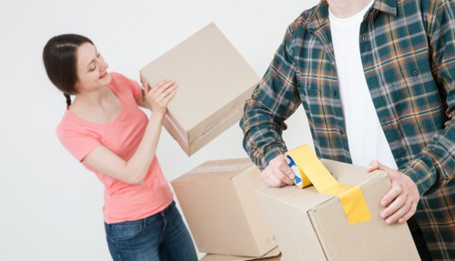 Careful lifting of boxes and household items in South London