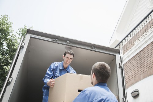 Trained movers using PPE while carrying furniture safely
